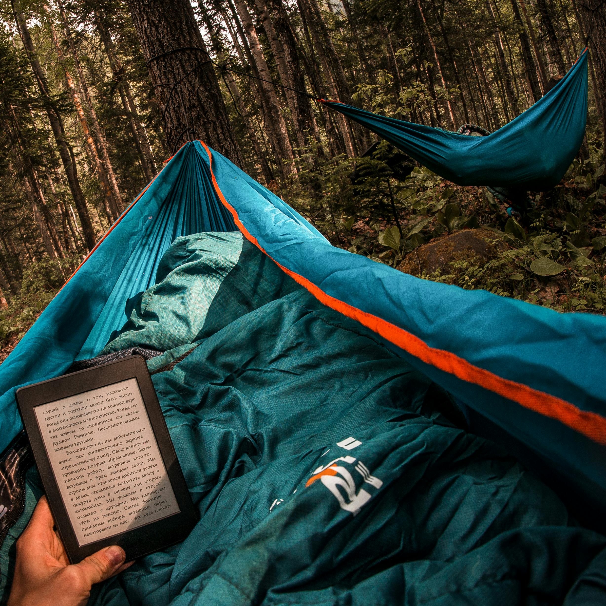Experience the tranquility of reading in a hammock amidst Buryatia's lush forest.